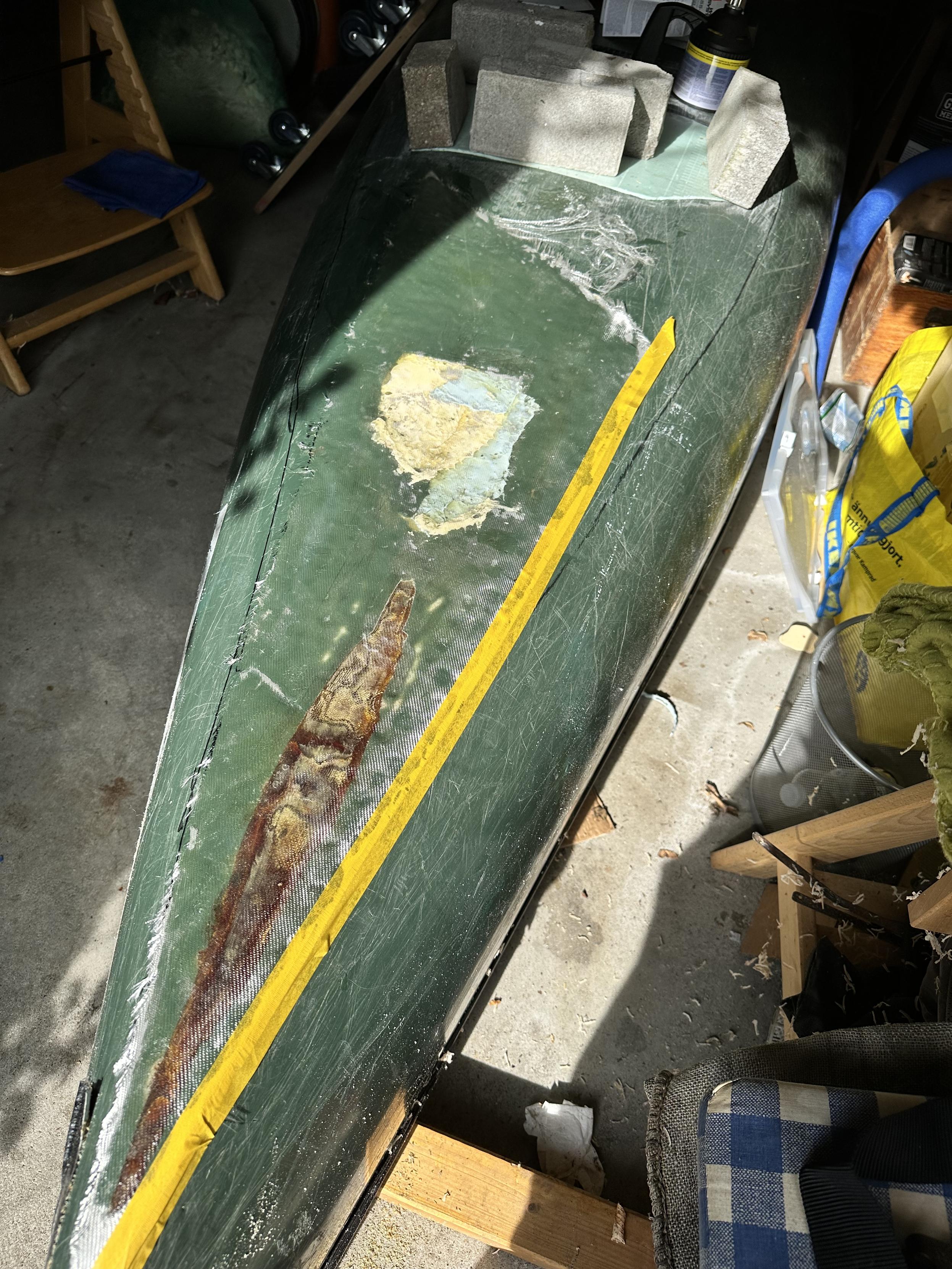 The glass fabric is wetted and the damaged areas below are now visible.